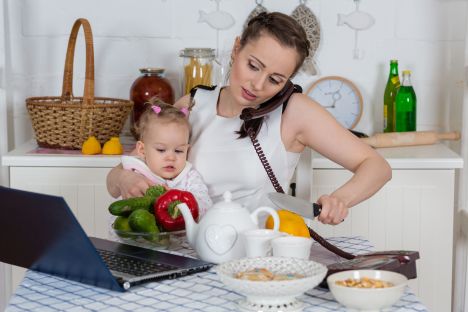 20109688 - young mother with little child sit at the dining table in the home kitchen.