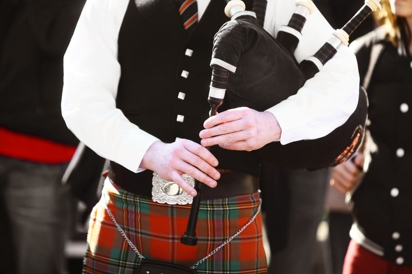 26991266 - color shot of a person holding a traditional bagpipe.